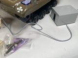 a toy tank that is sitting on a table next to a box