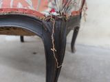 a close up of a chair with a red and black upholstered seat