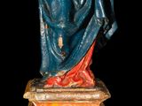 an old statue of a woman holding a baby in her arms