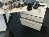 a desk with a lot of electronics on top of it