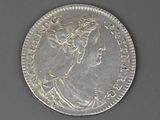 a silver coin with an image of a woman on it