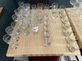 a lot of empty glasses on a table with a price tag