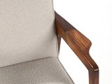 an upholstered chair with a wooden frame and a beige upholstered seat