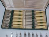 many knives in a case on the table
