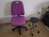 a purple office chair next to a black stool