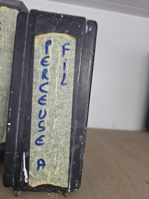 two black boxes with blue writing on them sitting on a table