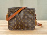 a louis vuitton cross body bag on a wooden table