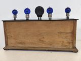 a wooden box with three blue bulbs on it