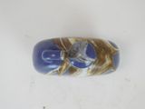 a picture of a blue and gold bead on a white surface