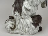 a figurine of a dog sitting on the ground