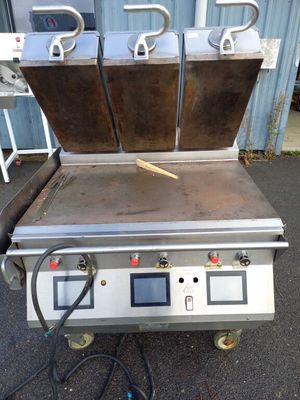an image of a commercial fryer with two pans on it