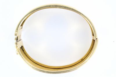 a gold ring with a white stone inside of it