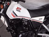 a white and black motorcycle parked in a garage