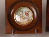 two wooden plaques with a painting of a woman and a man on them
