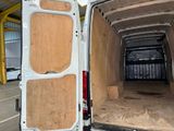 a white van with a wooden door open in a parking lot