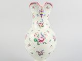 a white vase with a floral design on it
