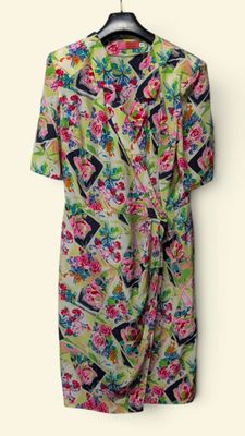 an image of a dress hanging on a hanger on a wall