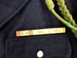 a close up of a person ' s jacket with a measuring tape in the pocket