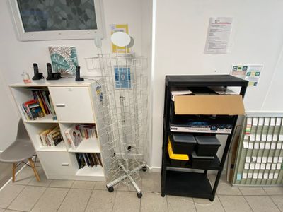 a book shelf and a chair in the corner of a room