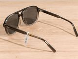 sunglasses on a wooden table with a white tag on it