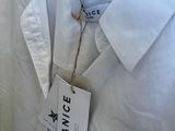 a close up of a white shirt with a tag on it