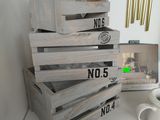 several wooden crates stacked on top of each other next to a cup of coffee
