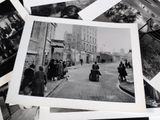 several black and white photos of people walking down a street