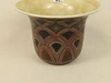 a brown and green bowl on a white table