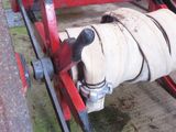 a red wagon that has a hose attached to it