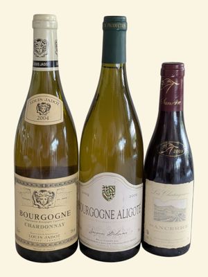 three bottles of wine sitting next to each other on a table
