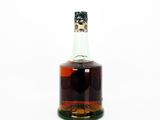 a bottle of liquor that is sitting on a white surface