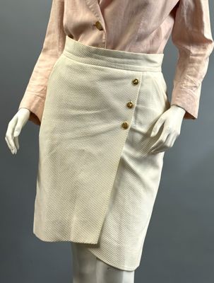 a mannequin wearing a pink shirt and white skirt