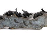 a piece of metal that has a bunch of birds on it