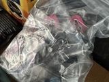 a plastic bag of food on a table next to a box of cookies