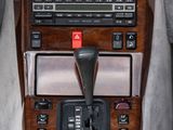 a car dashboard with a wooden dash panel and buttons