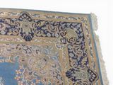 a blue and gold rug on a white surface