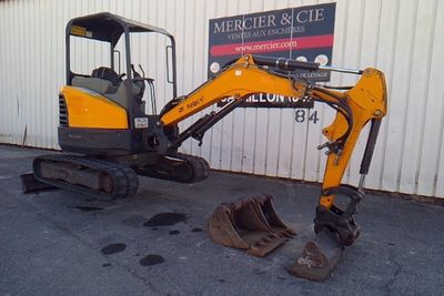 an image of a small excavator parked in front of a building