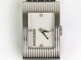 an image of a close up of a wrist watch on a white surface