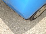 a blue car that is parked on the side of the road