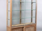 a display case with glass shelves and a wooden base