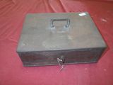 a metal box with a lock on it on a red surface