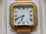 a gold and silver watch with roman numerals on it