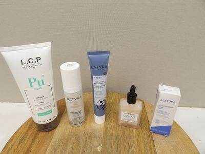 a wooden tray with various skin care products on it