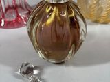 three different colored glass vases sitting on a table