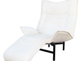 white reclining lounger with pillows and a pillow on top of it
