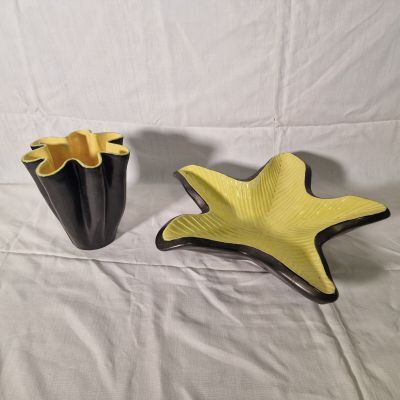 yellow and black starfish shaped vases on a white background