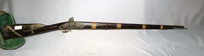 a very old pipe with a green handle on a white surface