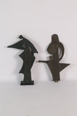 two figurines of a man and a woman on a table