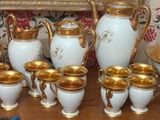 many vases on a table with a mirror in the background