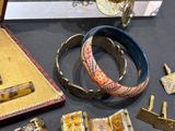 many different types of jewelry on display on a table
